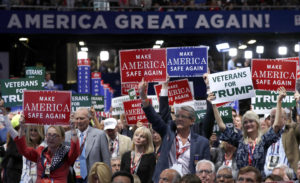 Delegates hold up signs and cheer during first day of the Republican National Convention in Cleveland, Monday, July 18, 2016. (AP Photo/Carolyn Kaster)